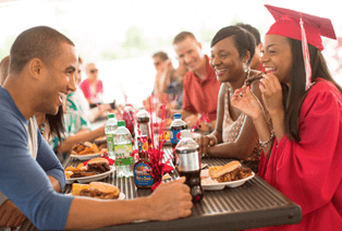 Graduates eating Famous Dave's BBQ at a party