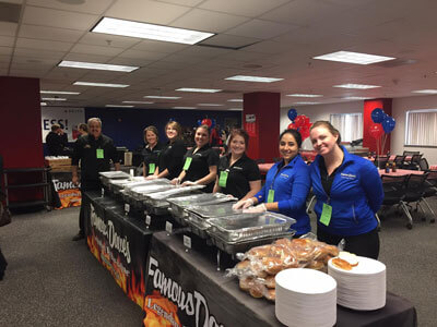 Famous Dave's BBQ team ready to serve BBQ at for a community donation event