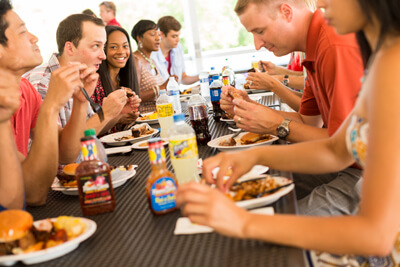 People eating Famous Dave's BBQ catering at a party