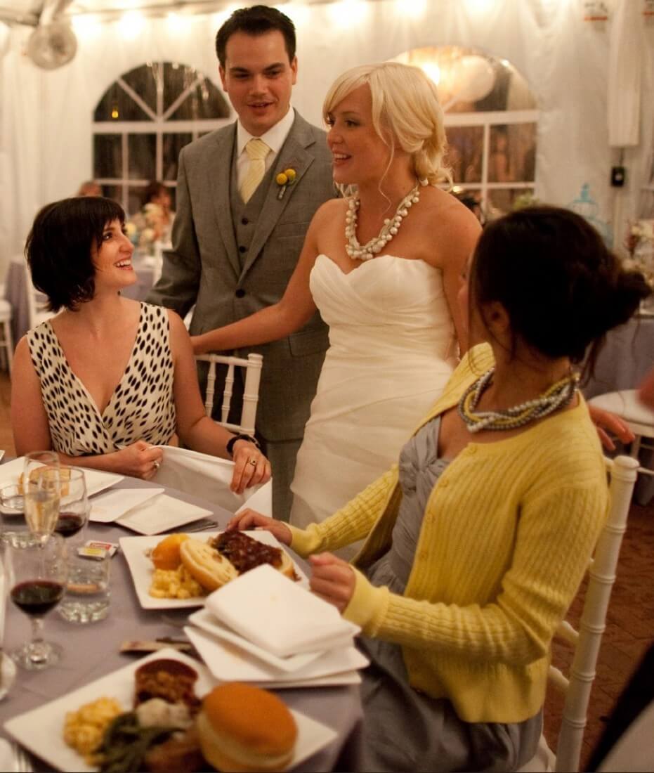 Couple interacting with guests having their wedding catered by Famous Dave's DMV Michigan location